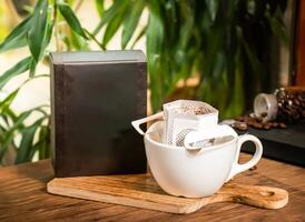 Single Serve Coffee Filter Pack served in box and cup isolated on table side view of taiwan drink photo