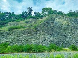 rocky mountains at the entrance to Prague, on which trees grow. Czech photo
