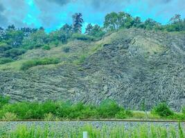 rocky mountains at the entrance to Prague, on which trees grow. Czech photo