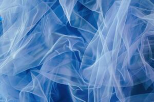A delicate light blue tulle texture creates a soft and ethereal background photo
