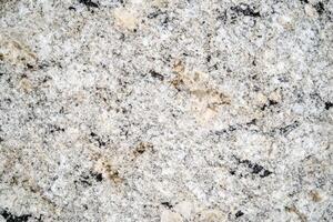 A granite texture background features a rugged, natural stone surface with speckled patterns photo