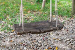 Empty old wooden swing in the park. Space for text. Activity and Relaxation concept photo
