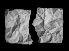 Crumpled paper on black background photo
