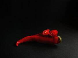 A red pepper on a black background photo