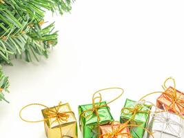 Part of Christmas tree and colorful gift boxes isolated on white background. Space for text. Top view. Flat lay. Christmas and Happy New Year concept photo