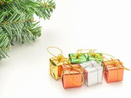 Part of Christmas tree and colorful gift boxes isolated on white background. Space for text. Top view. Flat lay. Christmas and Happy New Year concept photo