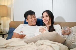 A caring Asian husband is talking with his beloved wife before going to bed together. photo