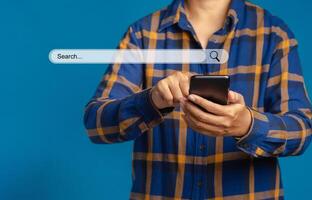 Search engine online concept. Close-up of hand a man in blue shirt using smartphone search for information interest on search engine web site. Technology and internet network concept photo