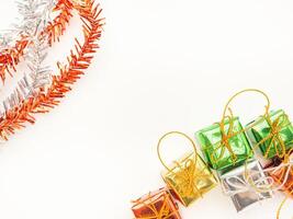 Part of Christmas tree and colorful gift boxes isolated on white background. Space for text. Top view. Flat lay. Christmas and Happy New Year concept photo