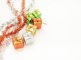 Part of Christmas tree and colorful gift boxes isolated on white background. Space for text. Top view. Flat lay. Christmas and Happy New Year concept photo