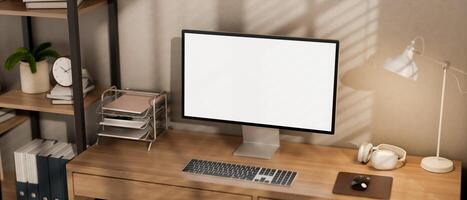 A minimalist computer desk featuring a computer and decor on the wooden desk in a room. photo