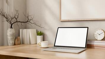 A laptop and minimal decorative objects on a wooden table in a minimal Scandinavian room. photo