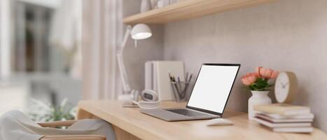 Side view of a laptop mockup and accessories on a table in a beautiful Scandinavian home office. photo