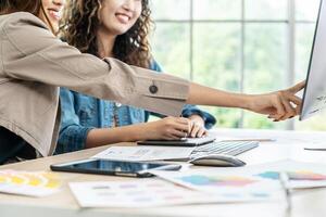 Collaboration of graphic design business people with computer in an office company. Two corporate women in creative marketing team working on project management, Designer teamwork, web design photo