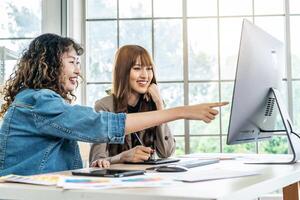 Collaboration of graphic design business people with computer in an office company. Two corporate women in creative marketing team working on project management, Designer teamwork, web design photo