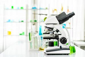 Colorful rows of laboratory or classroom test tubes and microscope with metal lens, Science and education. Scientific experiment, Researcher, Concept of medical or science laboratory, photo
