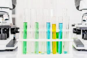 Colorful rows of laboratory or classroom test tubes and microscope with metal lens, Science and education. Scientific experiment, Researcher, Concept of medical or science laboratory, photo