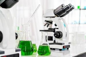 Colorful rows of laboratory or classroom test tubes and microscope with metal lens, Science and education. Scientific experiment, Researcher, Concept of medical or science laboratory, photo
