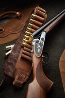 Classic trigger double-barreled hunting rifle on a green background. Smooth-bore hunting rifle open for reloading. Concept postcards for hunters. photo