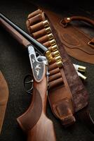 Classic trigger double-barreled hunting rifle on a green background. Smooth-bore hunting rifle open for reloading. Concept postcards for hunters. photo