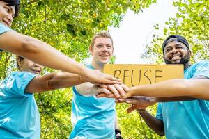 Group of volunteers stand to put your hands up and raise your hands together for help to save nature collecting garbage, Natural environment, pollution concept, Cleaning of nature from waste photo