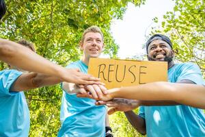 Group of volunteers stand to put your hands up and raise your hands together for help to save nature collecting garbage, Natural environment, pollution concept, Cleaning of nature from waste photo