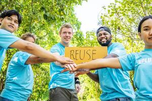 Group of volunteers stand to put your hands up and raise your hands together for help to save nature collecting garbage, Natural environment, pollution concept, Cleaning of nature from waste photo