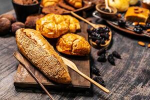 Selection of bread and loaf with cereals bread and bakery, breadsticks on wooden table in dark background with copy space photo