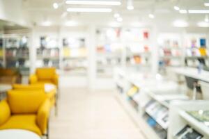 Abstract blurred of the interior of the public library with wooden tables, chairs and books in bookshelves. use for background or backdrop in book shop business or education resources concepts photo