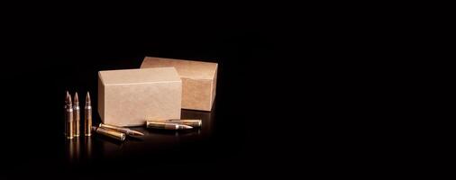 Cartridges for a rifle on a dark back. Different boxes with ammunition for weapons. Bullets for carbines and rifles. photo