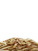 cartridges for 308 caliber rifle on a white background. a bunch of ammo. cartridges scattered on a light background photo