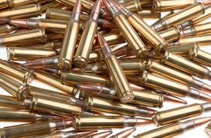 Bullet isolated on white background. Rifle bullets close-up on white back. Cartridges for rifle and carbine. photo