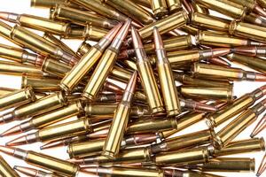 Ammunition for weapons. Lots of rifle cartridges on a white back photo