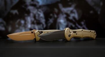 Khaki military pocket folding knives. Compact metal sharp knife with a folding blade. Blurred back. photo