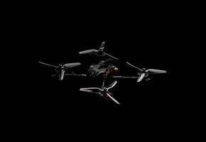 Modern FPV drone on a black background. Four-engine aircraft on the radio control. Drone for racing, filming and entertainment. photo