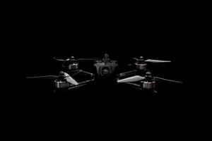 Modern FPV drone on a black background. Four-engine aircraft on the radio control. Drone for racing, filming and entertainment. photo