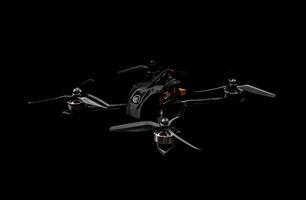 Modern FPV drone on a black background. Four-engine aircraft on the radio control. Drone for racing, filming and entertainment. photo