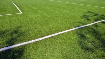 Artificial football turf with a white dividing line. Texture of Perfect green lawn on the football field. photo