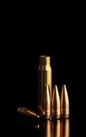 Bullet isolated on black background with reflexion. Rifle bullets close-up on black photo