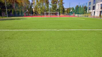 Artificial turf football pitch near school. photo