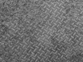 Texture and background of old flat dry concrete surface with diamond pattern and signs of light wearing photo