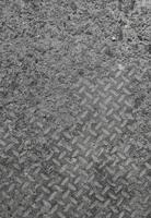 Texture and background of old flat dry concrete surface with diamond pattern and signs of light wearing photo