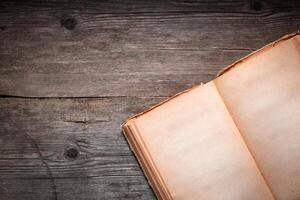 Vintage book, open, on old wooden table, with clipping path. Open Book blank on old wooden background. book with blank pages photo
