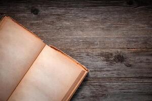 Vintage book, open, on old wooden table, with clipping path. Open Book blank on old wooden background. book with blank pages photo