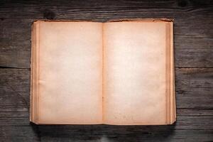 Vintage book, open, on old wooden table, with clipping path. Open Book blank on old wooden background. book with blank pages photo