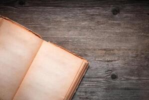 Vintage book, open, on old wooden table, with clipping path. Open Book blank on old wooden background. book with blank pages photo
