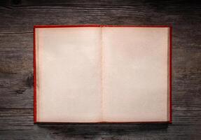 Vintage book, open, on old wooden table, with clipping path. Open Book blank on old wooden background. book with blank pages photo