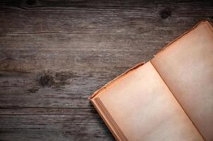 Vintage book, open, on old wooden table, with clipping path. Open Book blank on old wooden background. book with blank pages photo