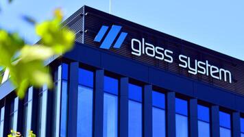 Warsaw, Poland. 31 July 2024. Wola business district in the city center with office centers and modern buildings. Urban landscape. Company signboard Glass System. photo