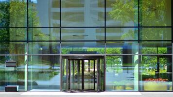 Entrance of the modern business city office building. Modern urban architecture. The front door of a office block, reflecting buildings in the glass photo